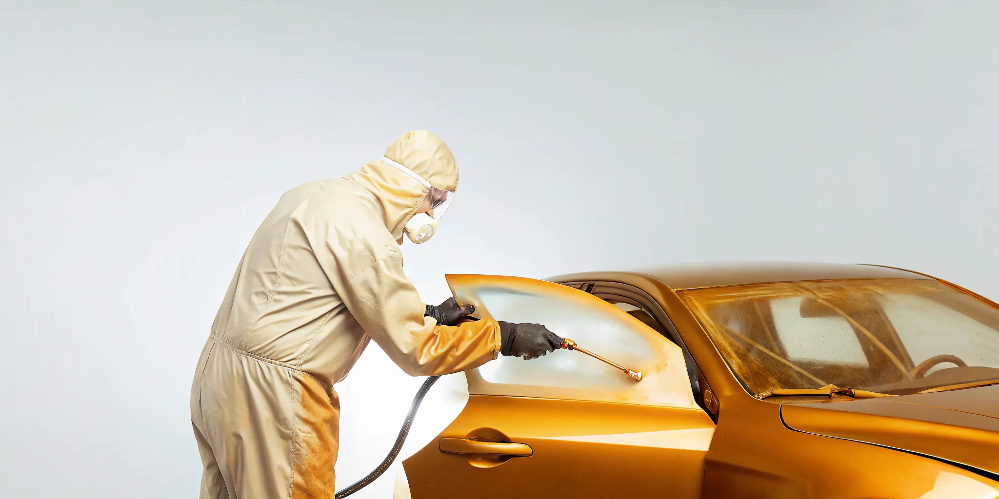 a-guide-to-a–m-auto-body-collision-repair-center-511390 A & M Auto Body technician performing collision repair and painting a car door.
