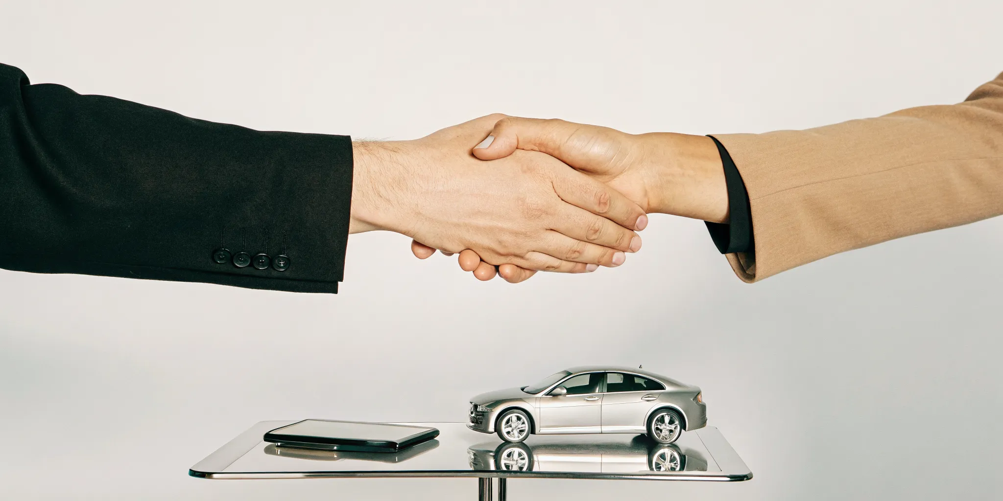 A handshake seals a direct repair collision center agreement between a shop and an insurer.