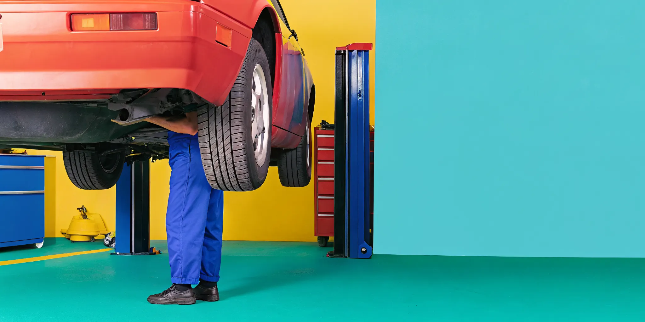 Technician inspecting wheel alignment after a collision