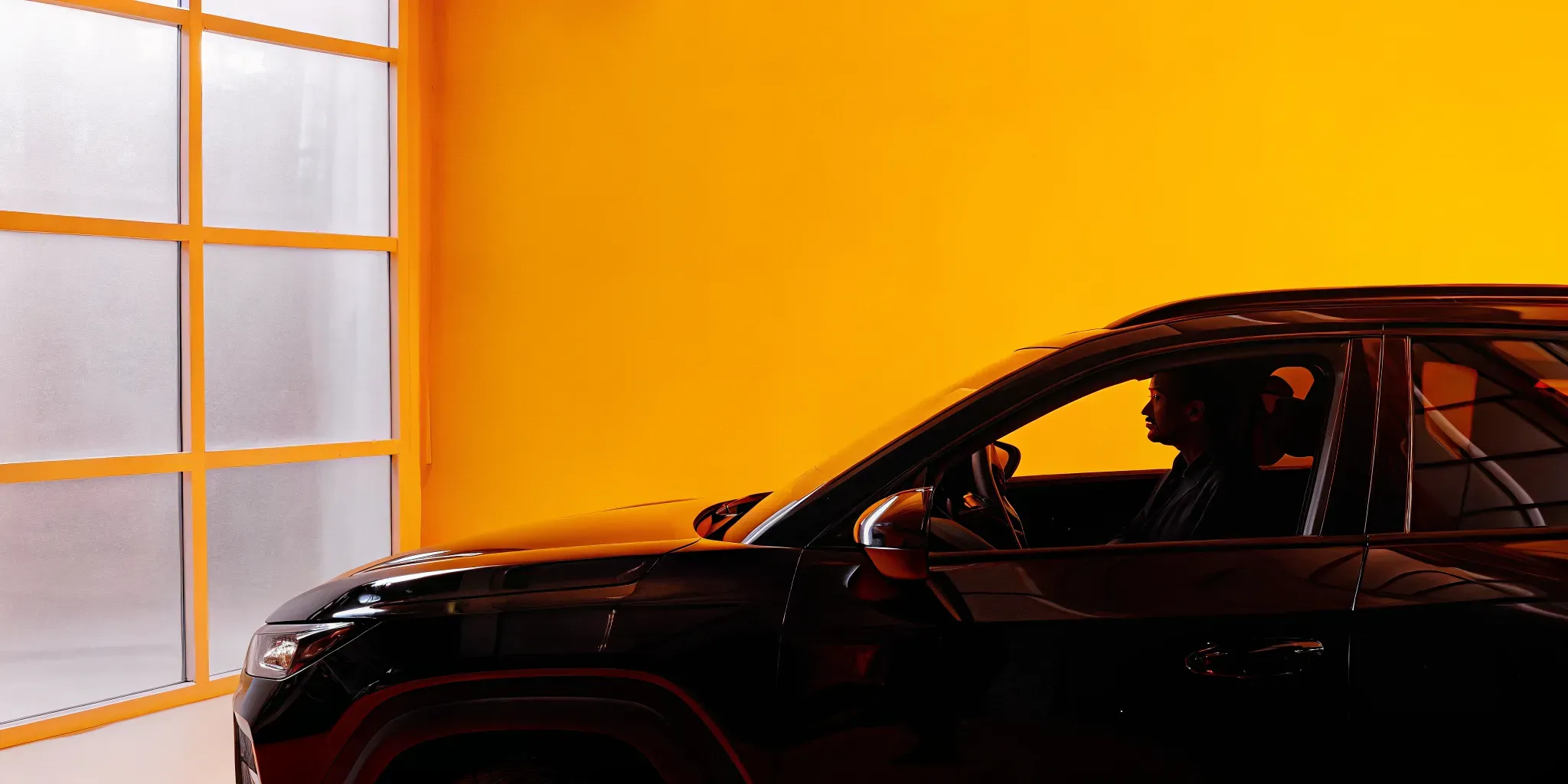 Modern Hyundai SUV parked inside a state-of-the-art collision repair shop with professional technicians and bright natural light