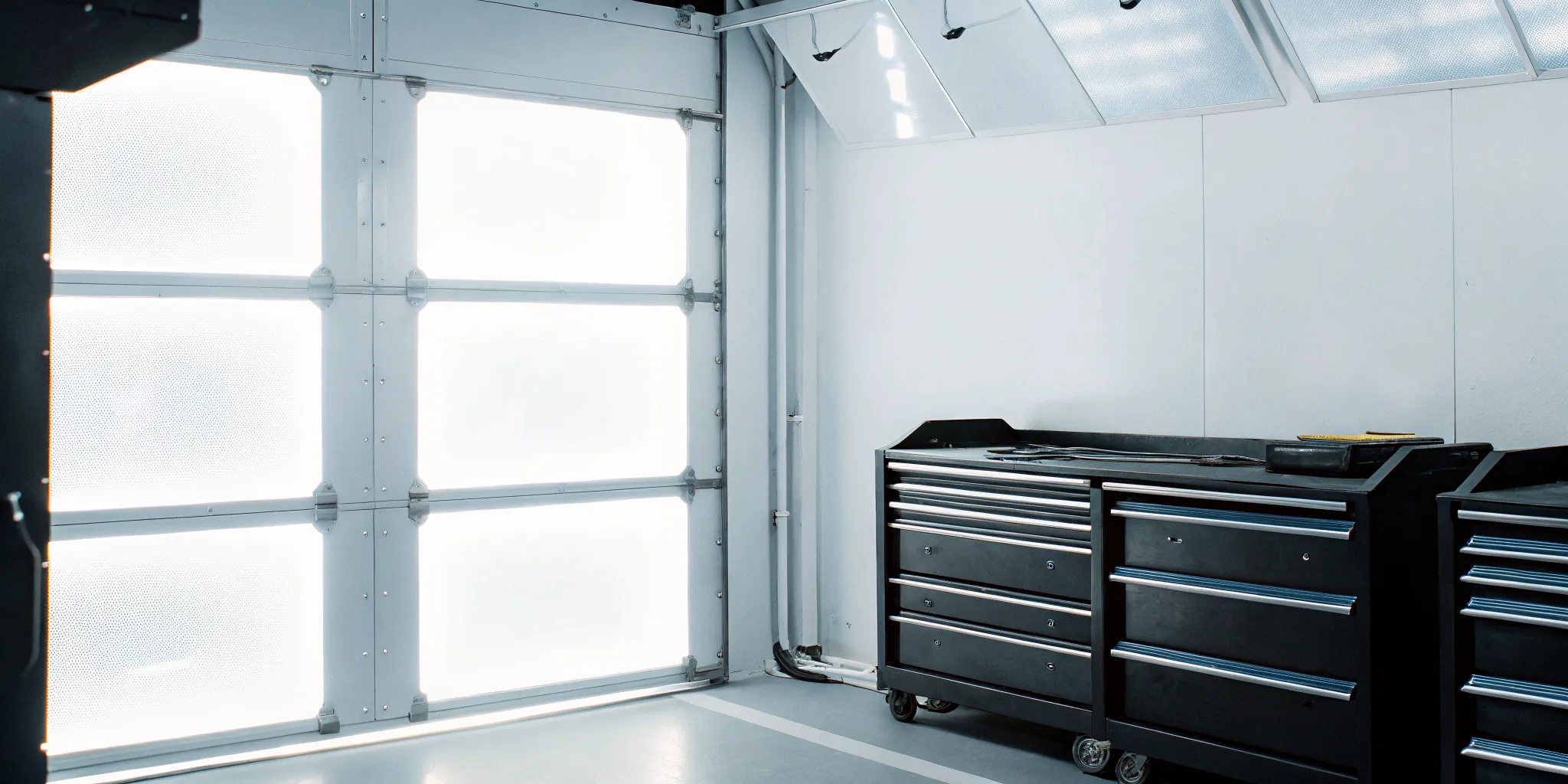 A clean and modern auto body shop calibration area with precision tools