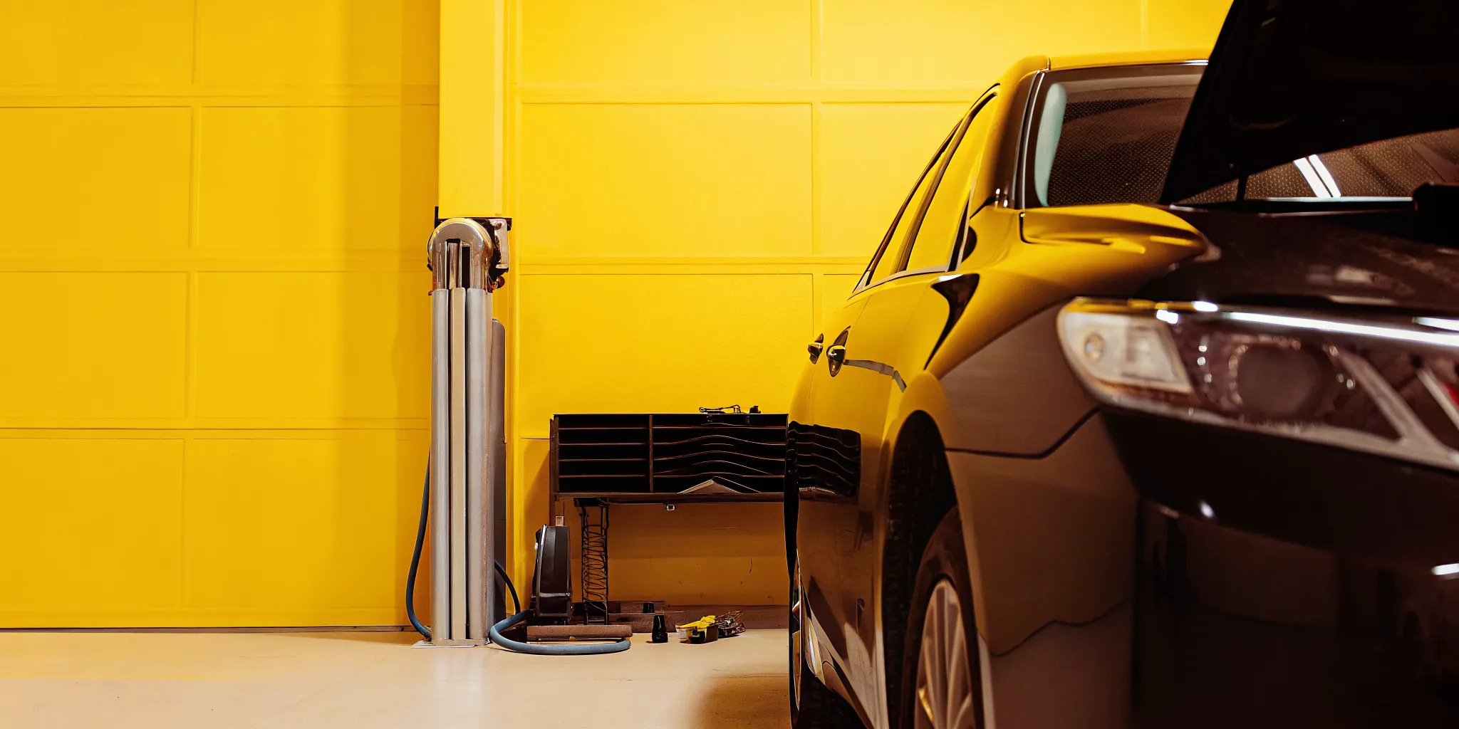Professional auto body collision repair shop in Orlando performing OEM certified repairs on a luxury sedan
